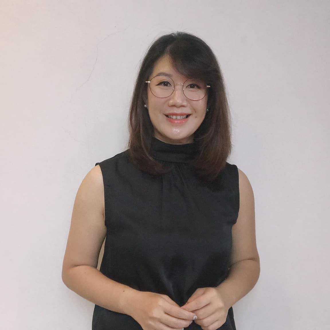 Featured trainer smiling in professional attire